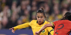 Australia’s Mary Fowler and China’s Li Mengwen compete for the ball.