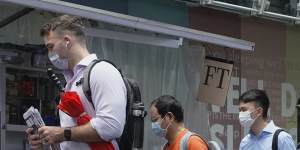 Customers queue up for last issue of Apple Daily at a newspaper booth at a downtown street in Hong Kong on Thursday. 