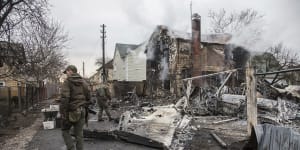 Ukrainian servicemen walk at fragments of a downed aircraft seen in in Kyiv,Ukraine.