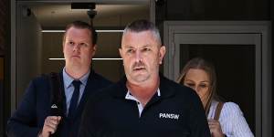 Senior Constable Kristian White (left) leaves the NSW Supreme Court in Sydney with his fiancé after he was found guilty by a jury of the manslaughter of Clare Nowland.