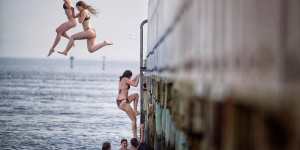 Teenagers jump off the pier in South Melbourne on Tuesday.