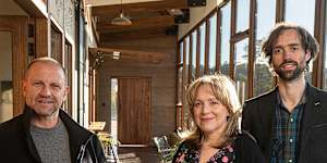 Grand Designs Australia host Anthony Burke (left) with Kate and Matt inside their earthship house. 