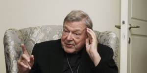 Cardinal George Pell answers a journalist's question during an interview inside his residence near the Vatican in Rome.