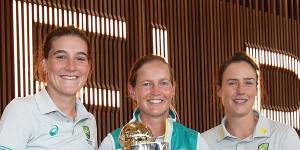 Annabel Sutherland,Meg Lanning and Ellyse Perry pose with the World Cup trophy after arriving home in Melbourne.