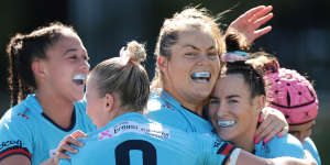 Maya Stewart is congratulated for scoring try for the Waratahs.