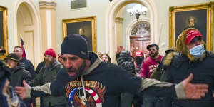 Online fury and disinformation,like the QAnon conspiracy theory signified on the rioter's jumper,was given physical form when rioters stormed the US Capitol.