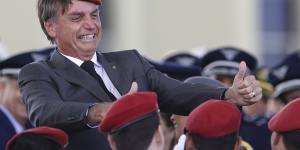  Jair Bolsonaro flashes two thumbs up as he poses for a photo with cadets during a ceremony marking Army Day,in Brasilia,Brazil. 