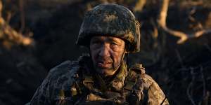 An infantry soldier takes cover from enemy fire near Vuhledar at dawn near Vuhledar,Ukraine. 