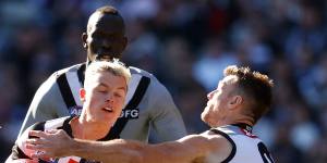 Jack Ginnivan is tackled by Robbie Gray.