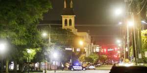 The steeple of Emanuel AME Church is visible as police close off the street after the shooting.