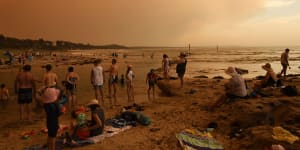 Holidaymakers at Currarong in Jervis Bay on the NSW South Coast watch as a huge bushfire approaches in December 2019.