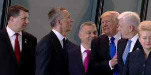 Getting ahead:US President Donald Trump pushes Montenegro Prime Minister Dusko Markovic,second right,at the NATO meeting in Brussels in May.