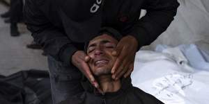 Palestinians mourn relatives killed in the Israeli bombardment of the Gaza Strip at a hospital morgue in Rafah.