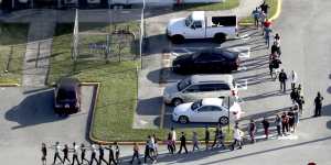 Students are evacuated by police from Marjorie Stoneman Douglas High School.