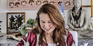 Libby and Tom Owen Edmunds at their dining table,under a lamp with porcelain leaves by Kris Coad. The painting above Libby’s head is Blowfly Dreaming by Kimberley artist Tracey Ramsay.