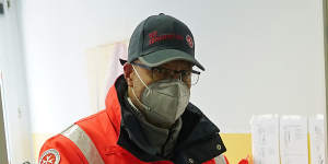 A German Red Cross worker carries a thermo container to pick up the Pfizer-BioNTech COVID-19 vaccine at a nursing home in Grossraeschen.