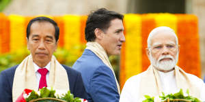 Canada’s Prime Minister Justin Trudeau (centre) walks past India’s Prime Minister Narendra Modi (right) and Indonesia’s President Joko Widodo during the G20 Summit in New Delhi.