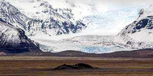 Solheimajokull Glacier – a tongue of the even more immense Myrdalsjokull Icecap – squats atop the country's most powerful volcano,hidden beneath 800 metres of ice.