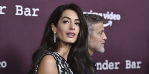 Amal Clooney (left) and George Clooney arrive at a movie screening in Los Angeles in 2021. 
