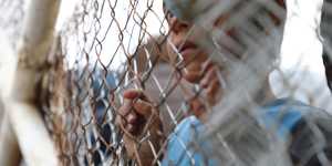 A child at the fence at al-Hawl camp in Syria. The camp houses the wives and children of former Islamic State fighters. 