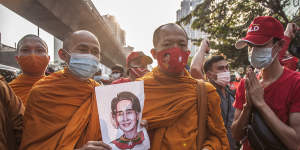 Thai monks hold a portrait of Aung San Suu Kyi during a demonstration outside the Burmese embassy in Bangkok.