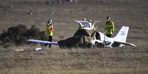Fire and Rescue personnel near the wreckage of a light plane which crashed near Braidwood on Tuesday,killing the pilot.
