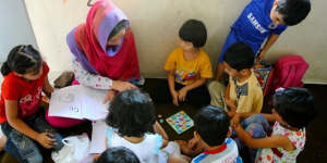 Welcome distraction:Children learning English at the centre. 