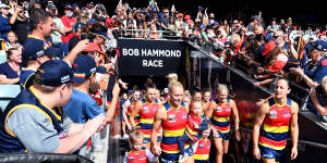 The Crows lead their team out of the race during the AFLW grand final match between the Adelaide Crows and the Brisbane Lions.