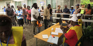 The first people to vote in the Bougainville independence referendum in the capital Arawa were the former commanders of the BRA (Bougainville Revolutionary Army) Ishmael Torama and Chris Uma,centre,standing with their children.