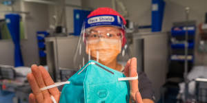 Australian Society of Anaesthetists president Dr Suzi Nou holds an N95 mask,which are required in Victoria for hotel quarantine staff and other frontline workers. Other states are still using surgical masks and face shields.