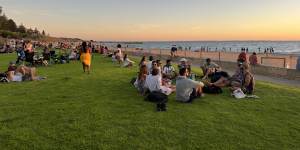 A multicultural mecca:locals and visitors gather at Wilson Park to watch the sun dipping into the Indian Ocean.