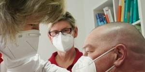 Dr Claudia Richartz inoculates a healthcare worker against COVID-19 in Brandenburg,Germany. 