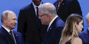 Prime Minister Scott Morrison greets Russian President Vladimir Putin at the G20 in 2018. Mr Morrison now says people who are invading other countries should not be at the summit.