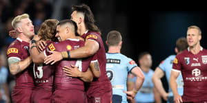 The Maroons celebrate Valentine Holmes’ try.