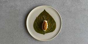 Salted sesame leaf with sea urchin.