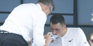 Australian Bernard Tomic using inhaler medication during his match on Tuesday.