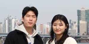 Kang Dong-hwan,25,a business information systems graduate,with his girlfriend Ji Su-hyeon,21 in Seoul.