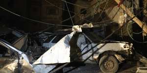 Destroyed vehicles and downed power lines on the grounds of Al Shifa Hospital.