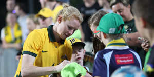 Clare Polkinghorne signs autographs after her record-breaking 152nd game for the Matildas.