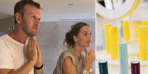 Style editor Damien Woolnough in the bathroom with beauty entrepreneur Trinny Woodall exploring the Trinny London skincare range,on one leg;part of the Trinny London range.