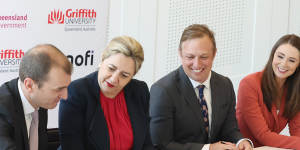 Dr Jean-Francois Toussaint from Sanofi signs the agreement with Premier Annastacia Palaszczuk and her deputy Steven Miles.