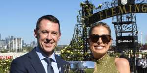 Craig McRae,along with wife Gabrielle,was all smiles holding the Australian Guineas trophy after his horse took out the feature race.