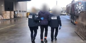 Federal police officers escort the 44-year-old man after his arrest.
