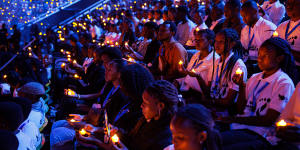 Young Rwandans take part in a vigil on the first of 100 days of remembrance of the genocide on April 7,2024,in Kigali. 