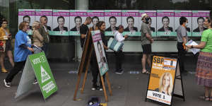 Residents queue to vote in person at Surry Hills Library on Saturday.