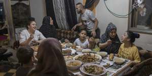The Rajabi family shares an Iftar meal,breaking the day’s Ramadan fast,on May 9.