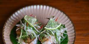 Betel leaves topped with prawn and chicken jungle sausage.