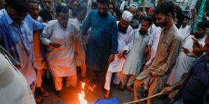Protesters in Pakistan on July 7 burn the Swedish flag in retaliation for someone burning the Koran in Sweden.