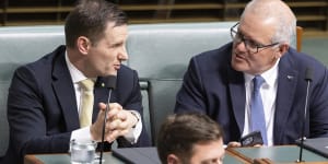 Alex Hawke and Scott Morrison sit next to each other in parliament,reflecting their longstanding political friendship.