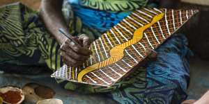 An artist at work at Tiwi Design.